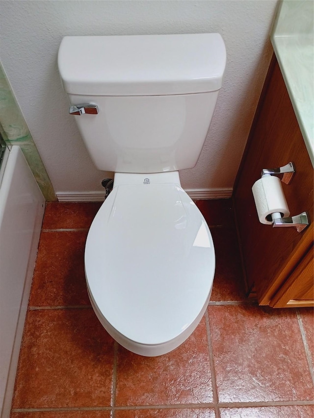 bathroom with toilet and baseboards