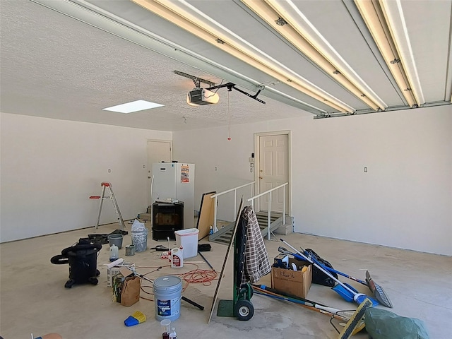 garage featuring freestanding refrigerator and a garage door opener
