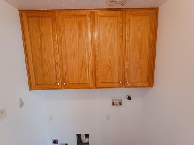 washroom featuring hookup for a washing machine, electric dryer hookup, visible vents, hookup for a gas dryer, and cabinet space