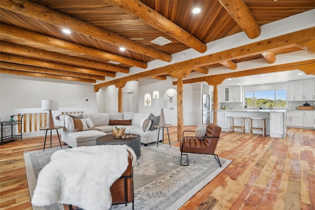 30A Arroyo Coyote, Santa Fe, NM 87508 - living room with light wood finished floors, recessed lighting, and a wooden ceiling with exposed beams