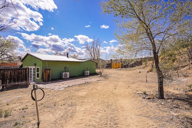 3112 Nm 14, Cerrillos, NM 87010 - back of house featuring metal roof, french doors, fence, and stucco siding