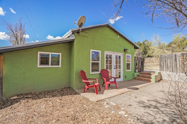 3112 Nm 14, Cerrillos, NM 87010 - back of property with a patio area, french doors, fence, and stucco siding