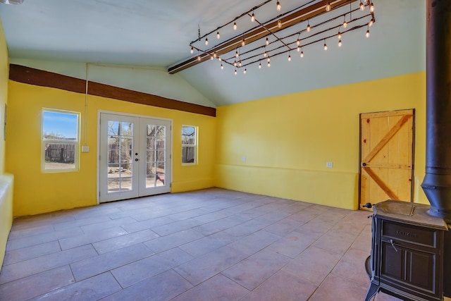 3112 Nm 14, Cerrillos, NM 87010 - tiled empty room with french doors, a wood stove, and lofted ceiling with beams