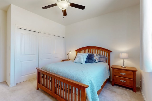 carpeted bedroom featuring a closet, baseboards, and ceiling fan