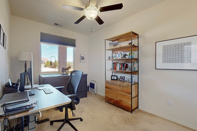 office space featuring light carpet, ceiling fan, baseboards, and visible vents