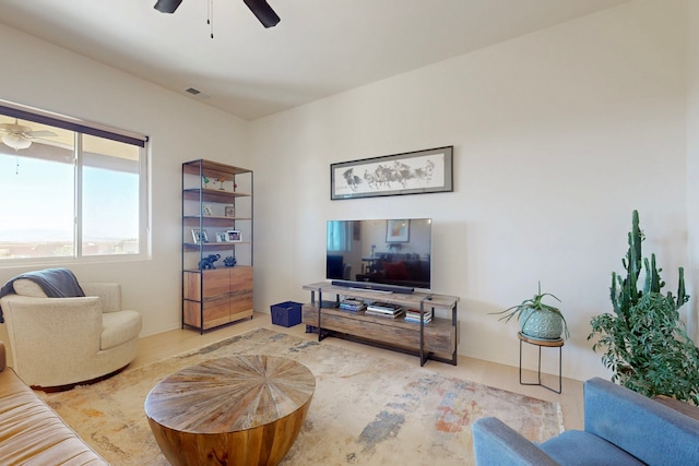 living area featuring wood finished floors, ceiling fan, and visible vents