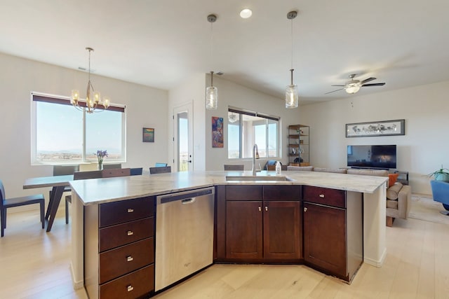 kitchen with open floor plan, pendant lighting, dishwasher, and a sink