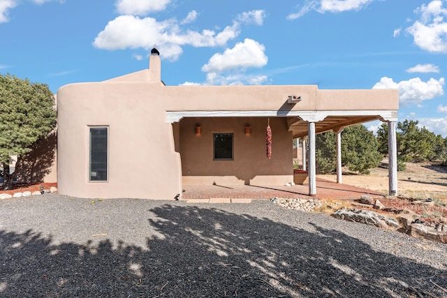back of house featuring a patio area and stucco siding