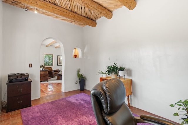 office with arched walkways, wood ceiling, and beamed ceiling