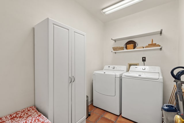 washroom with washer and dryer, laundry area, and light tile patterned floors
