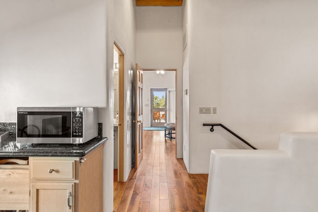 hallway featuring light wood-type flooring and an upstairs landing