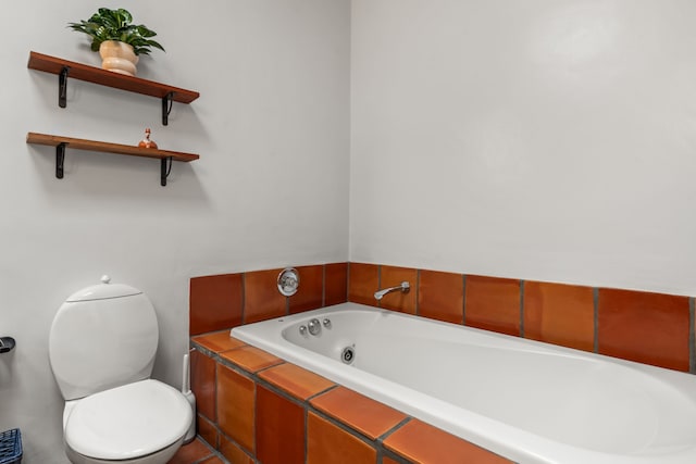 bathroom featuring toilet and a garden tub