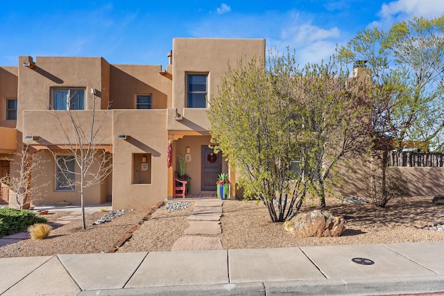 pueblo-style home with stucco siding