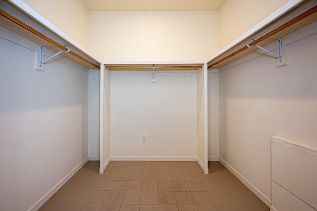 walk in closet featuring light tile patterned flooring