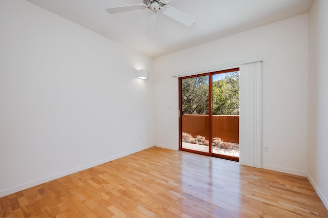 empty room with baseboards, light wood finished floors, and a ceiling fan