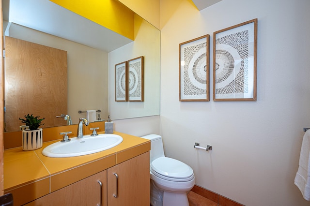 bathroom with toilet and vanity