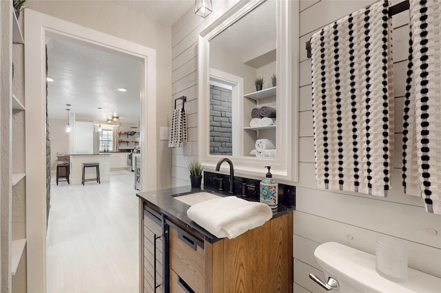1221B N Orchard, Espanola, NM 87532 - bathroom with vanity, toilet, and wood finished floors