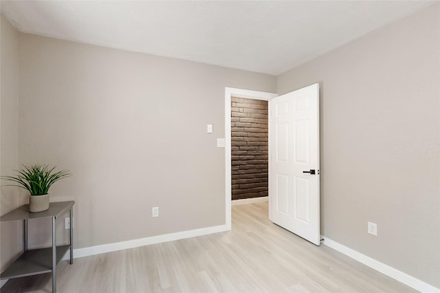 unfurnished room featuring light wood-style flooring and baseboards