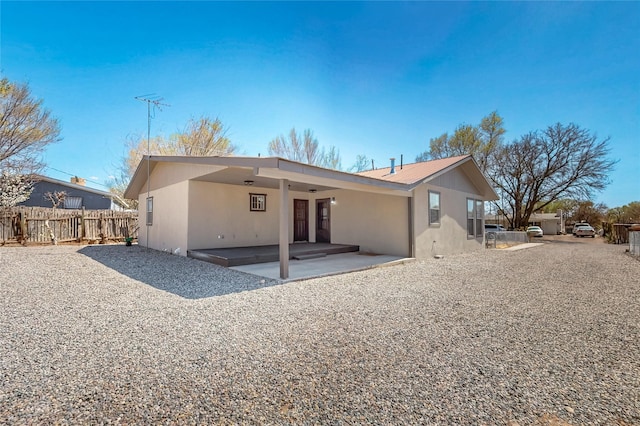back of property featuring a patio area, fence, and stucco siding