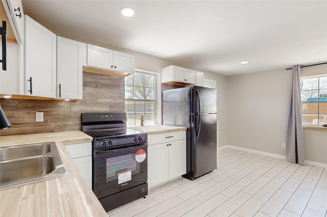 kitchen featuring backsplash, white cabinets, black appliances, and recessed lighting