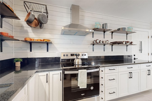 kitchen with wall chimney range hood, open shelves, and electric stove