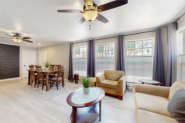 1221B N Orchard, Espanola, NM 87532 - living area featuring ceiling fan, light wood-type flooring, and a textured ceiling