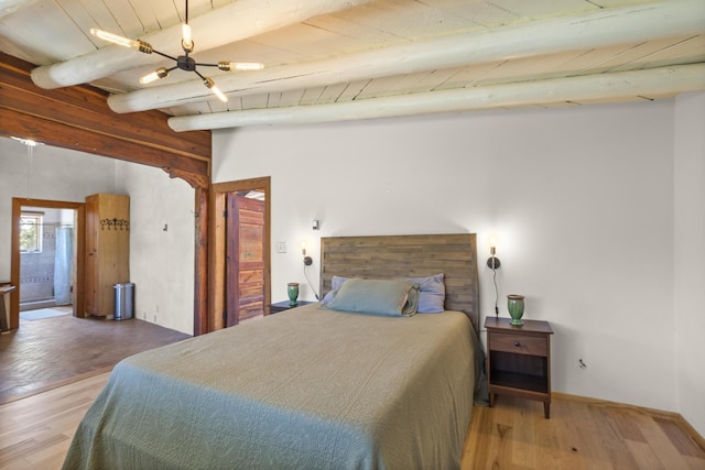bedroom featuring wooden ceiling, beamed ceiling, and wood finished floors