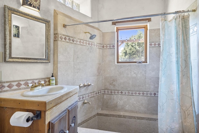 bathroom with decorative backsplash, tiled shower, and vanity