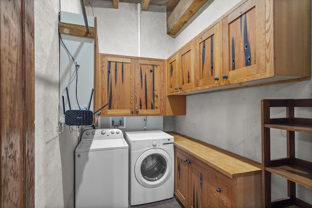 laundry area featuring washing machine and clothes dryer and cabinet space