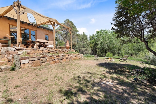 view of yard with a patio area and a fire pit