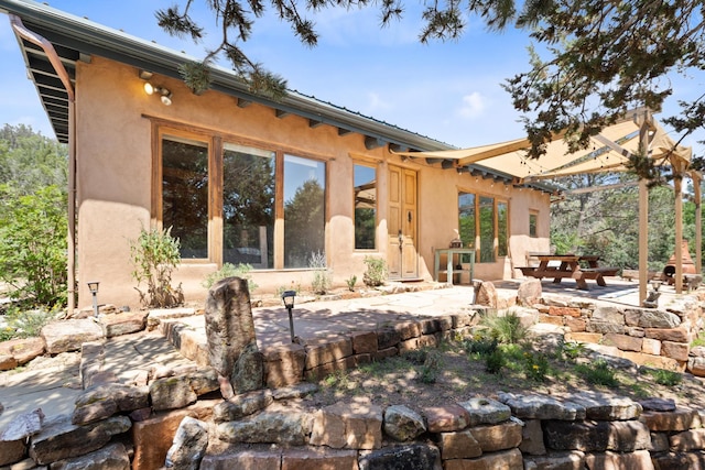 back of house featuring a patio and stucco siding