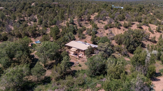 birds eye view of property featuring a wooded view