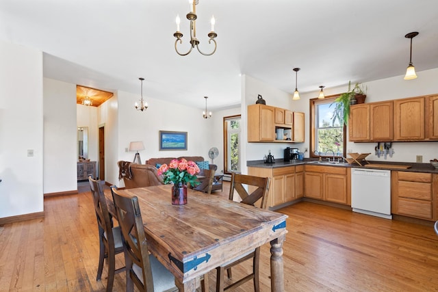 dining room with baseboards, a chandelier, light wood-style floors, and a healthy amount of sunlight