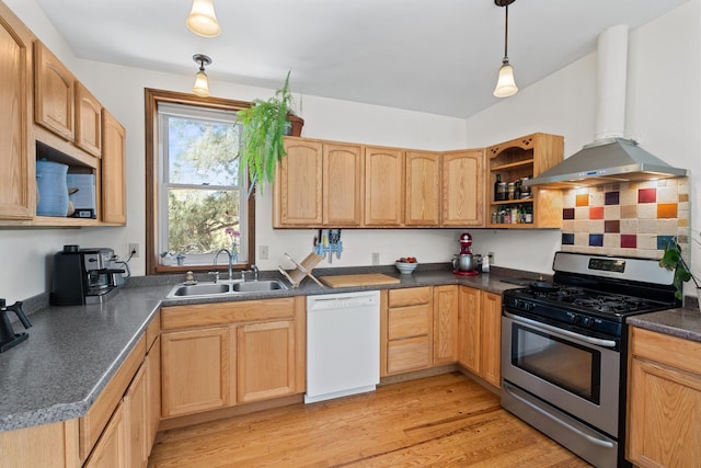 kitchen featuring gas stove, dark countertops, white dishwasher, range hood, and a sink