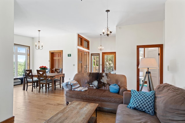 living room with a chandelier and light wood-style flooring