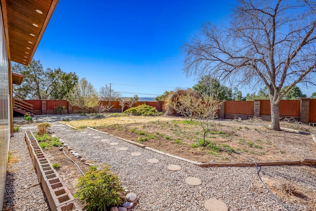 view of yard with a garden and a fenced backyard