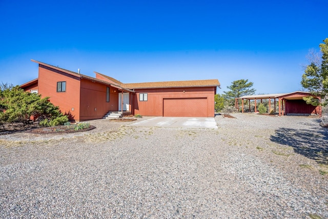 view of front of house featuring concrete driveway and an attached garage