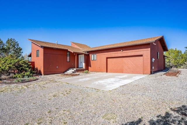 single story home featuring concrete driveway and a garage