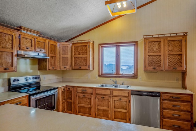 kitchen with a sink, appliances with stainless steel finishes, under cabinet range hood, brown cabinetry, and lofted ceiling