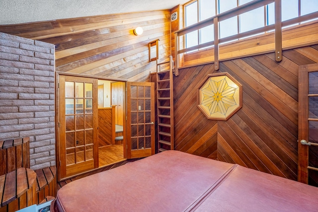 bedroom with wooden walls and beamed ceiling