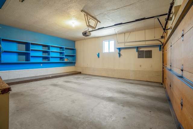 garage featuring a garage door opener and electric panel
