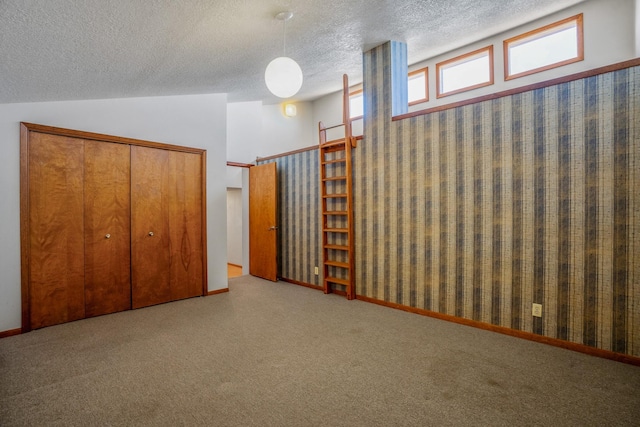 basement featuring carpet flooring, a textured ceiling, and baseboards