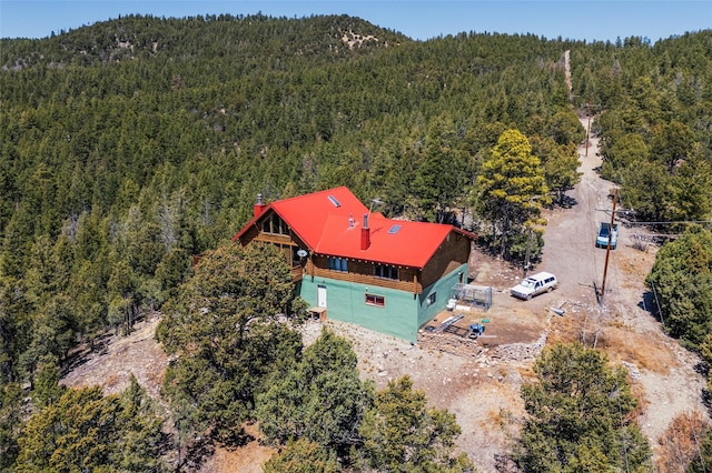 387 County Road B64, Pecos, NM 87552 - aerial view of property and surrounding area with a forest and a mountainous background