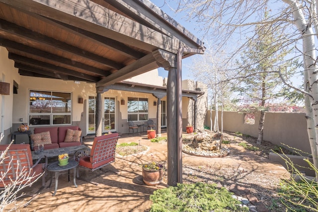 view of patio / terrace with an outdoor living space and fence