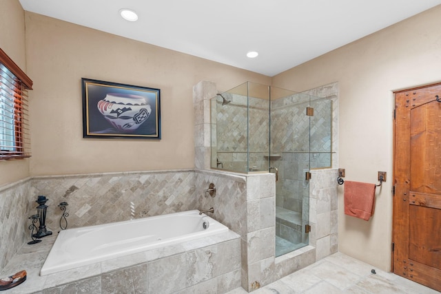 bathroom with a shower stall and a bath