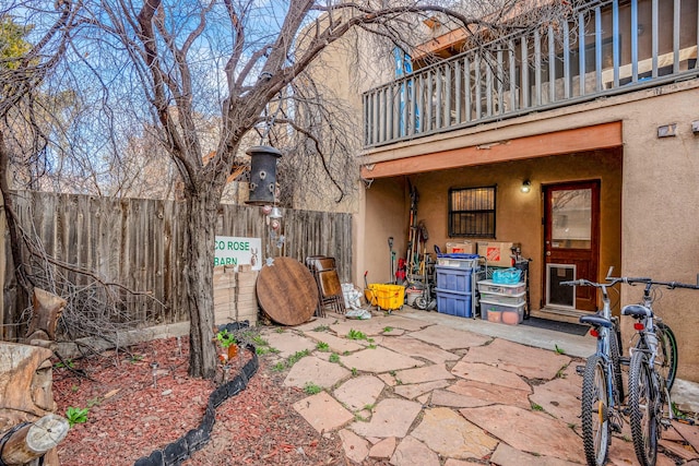 view of patio / terrace featuring a balcony and fence