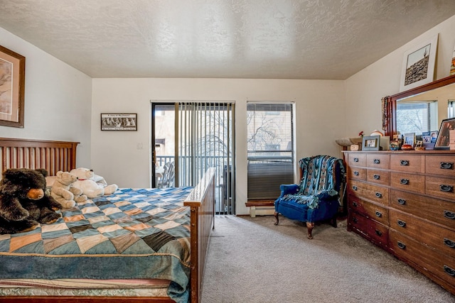 bedroom featuring access to outside, a textured ceiling, multiple windows, and carpet floors