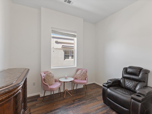 living area featuring dark wood finished floors and baseboards