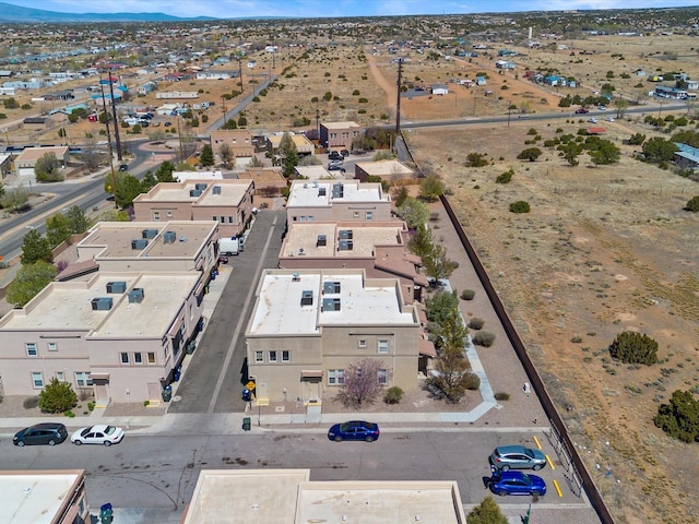 aerial overview of property's location featuring a mountainous background and nearby suburban area