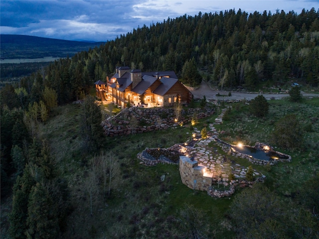 drone / aerial view featuring a wooded view
